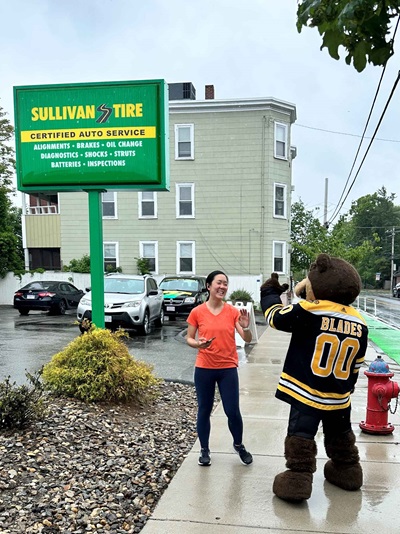 Blades the mascot giving a woman a high five in the rain