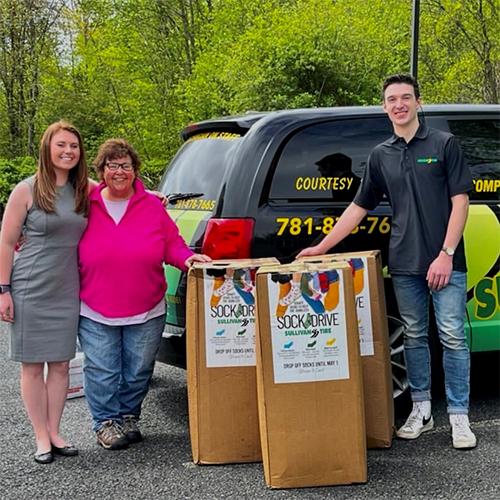 Sullivan Tire team delivering socks to the Wellspring House Organization
