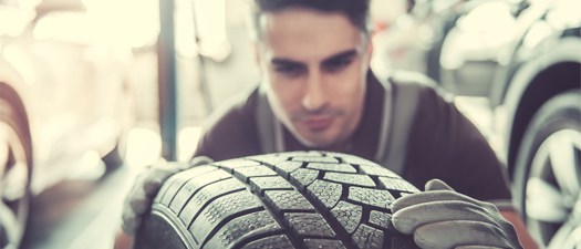 Technician examining tire