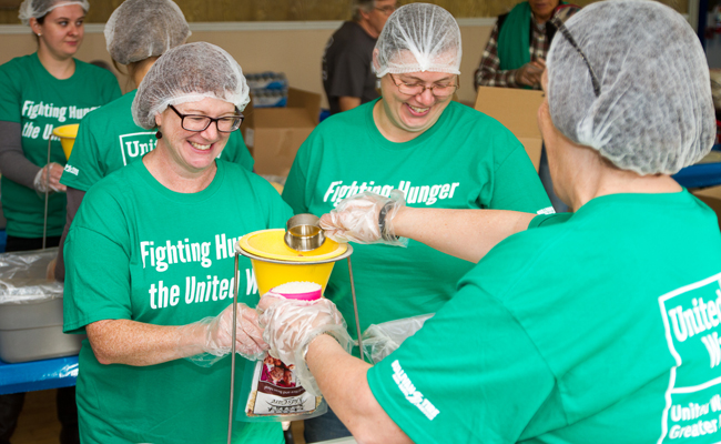 Sullivan Tire team packaging food for United Way